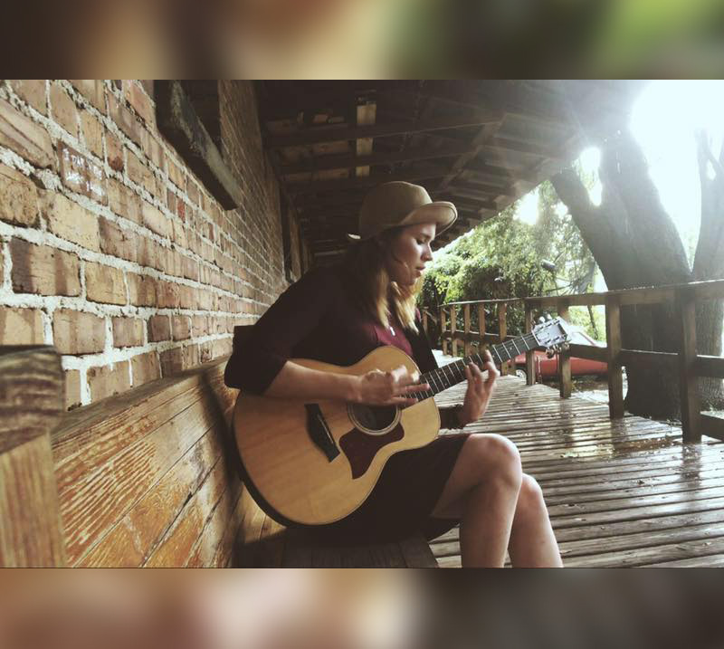 Rachel Hilman playing guitar